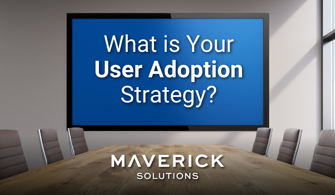 A conference room with a wooden table and a large tv screen. On the screen it reads, "What is Your User Adoption Strategy?" This urges readers to think through how data-driven adoption helps bolster digital adoption strategies.